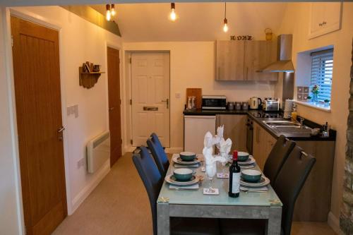 a kitchen with a table and chairs and a kitchen with a table and chairsktop at The Nest Close to York with Hot Tub in Barmby on the Marsh
