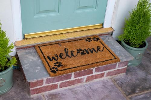 a welcome mat in front of a door at The Nest Close to York with Hot Tub in Barmby on the Marsh