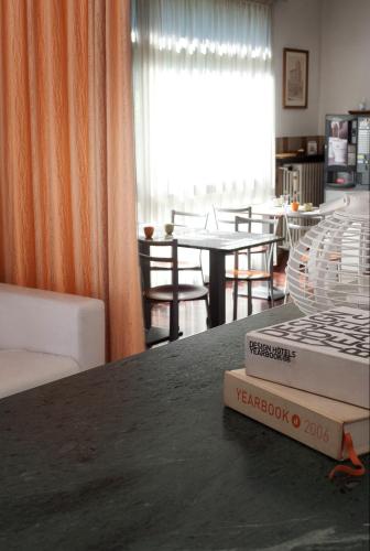 a room with a table with a book on top of it at Hotel Caselle in San Lazzaro di Savena