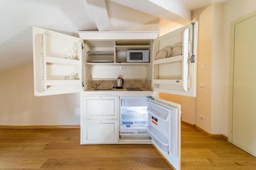 a kitchen with white cabinets and a sink at Al Torrione in Collecchio