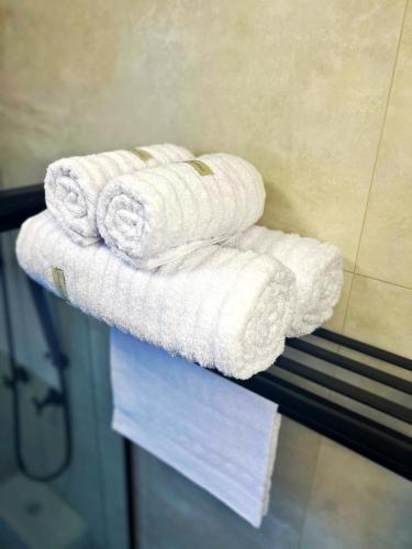a stack of towels on a counter in a bathroom at Cozy House in Rio de Janeiro