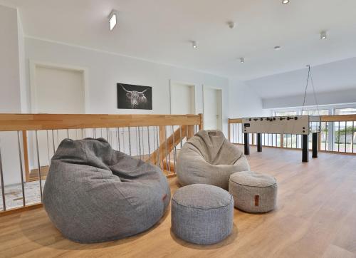 a living room with two bean bags and a table at NEU Villa Heidetraum, 20 Gaeste, Sauna, Pool in Dorfmark