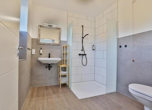 a bathroom with a shower and a sink and a toilet at NEU Villa Heidetraum, 20 Gaeste, Sauna, Pool in Dorfmark