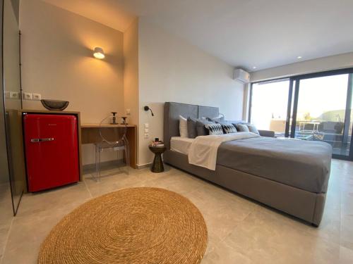 a bedroom with a large bed and a red cabinet at Luxury Suite with a queens double bed stunning sea vews and private Jacuzzi in Megali Ammos