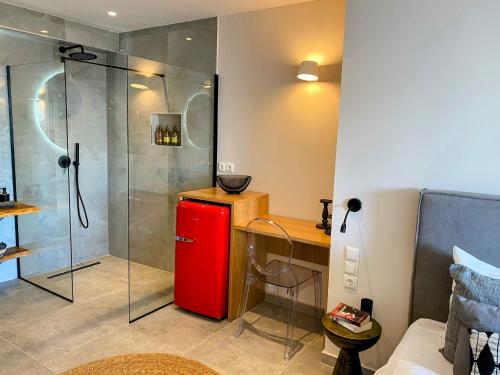 a bathroom with a red refrigerator and a shower at Luxury Suite with a queens double bed stunning sea vews and private Jacuzzi in Megali Ammos