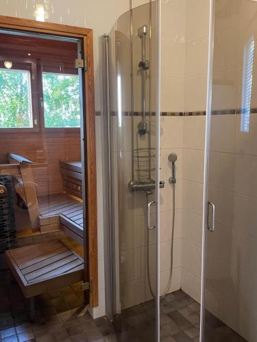 a bathroom with a shower and a walk in showeroser at Rantahelmi-huvila in Eurajoki