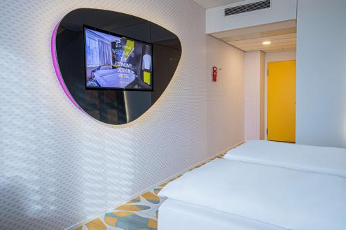 a bathroom with a toilet and a mirror at Prize by Radisson, Bern City in Bern