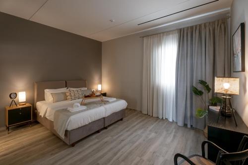a bedroom with a bed and a large window at Athens Soho Lofts -Evaggelistrias 18 in Athens