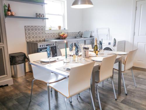a dining room with a table and chairs at Canning Cottage in Limavady