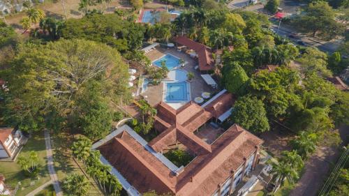 an overhead view of a house with a pool and trees at Hotel Girardot Resort by On Vacation in Girardot