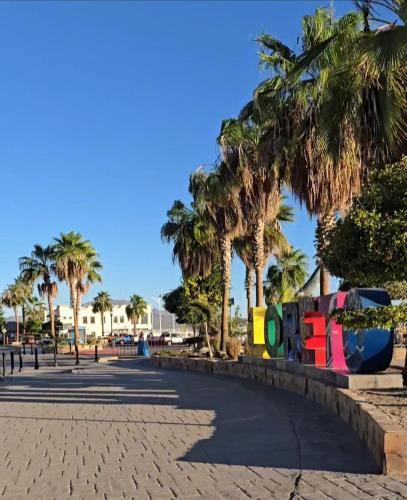 a park with palm trees and a playground at Hotel Loreto Palmar in Loreto