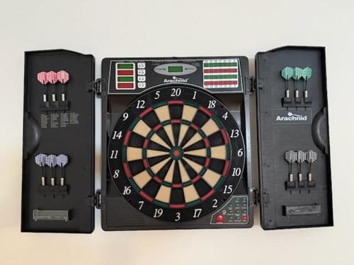 a dart board with a game controller and controllers at BLOOM - Luxe et Confort en forêt in Valcartier Station