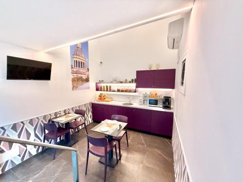 a kitchen with purple cabinets and a table and chairs at Ad Maiora - Design Rooms in Ragusa