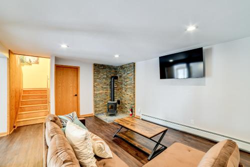 a living room with a couch and a table at Golf, Fish and Ski Retreat with Game Room in Thompson in Thompson
