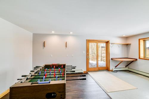 a room with a pool table in the middle of it at Golf, Fish and Ski Retreat with Game Room in Thompson in Thompson