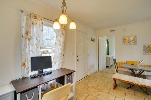 a living room with a desk with a computer on it at 2 Mi to South Boston Speedway Cozy Tiny Home! in South Boston