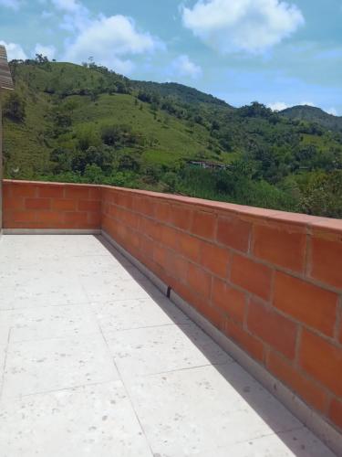 a brick wall with a view of a mountain at HOSPEDAJE MARIN in Concepción