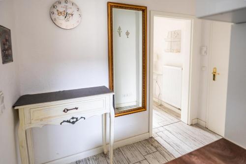a mirror on a wall next to a white dresser at Villa Backstein OBO19 in Schwerin