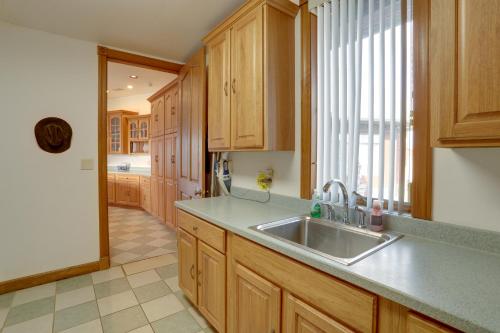 a kitchen with a sink and wooden cabinets at 366 Shared Acres, Lake Access: Ozark Getaway! in Fairfield Bay