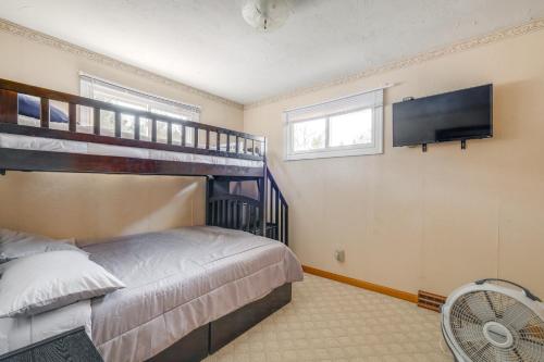 a bedroom with a bunk bed and a flat screen tv at Lake Views and Private Dock Radford Retreat! in Radford