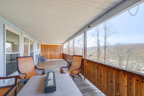 a porch with two chairs and a table on it at Lake Views and Private Dock Radford Retreat! in Radford
