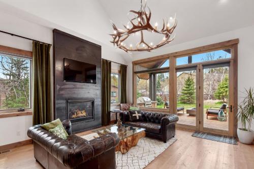 a living room with a couch and a fireplace at Lodge at Whitefish Lake in Whitefish