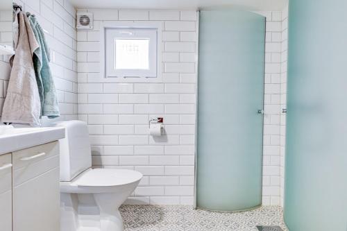 a bathroom with a toilet and a glass shower door at Prästkragen in Ullared