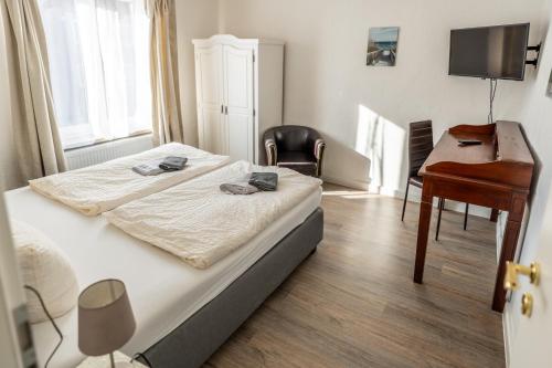 a bedroom with two beds and a desk and a piano at Villa Backstein OBO19 in Schwerin