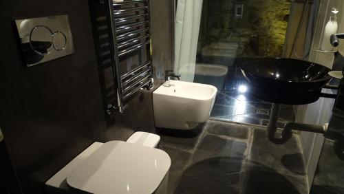 a bathroom with a white toilet and a sink at AgriIlGeco I - L Angolo di Papà Gigi - by HOST4U in Civezza