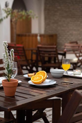 a wooden table with two slices of oranges on it at U-Sense For You Hostel Sevilla in Seville