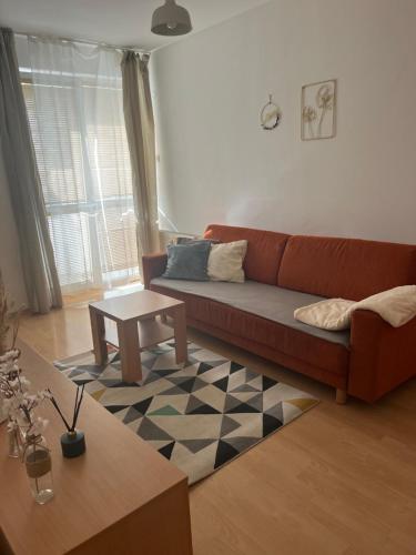 a living room with a couch and a table at Apartmán Neva Trnava in Trnava