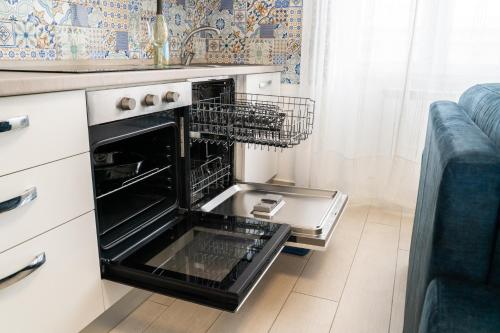 an oven with its door open in a kitchen at DanysHome Giove davanti al mare in Terracina