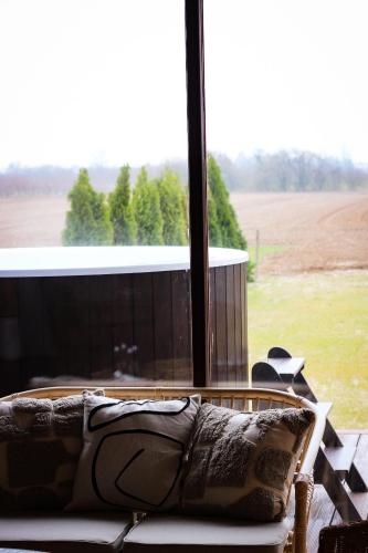 a couch in front of a window with a view of a field at Gościniec Gryszczeniówka & SPA in Wargowo