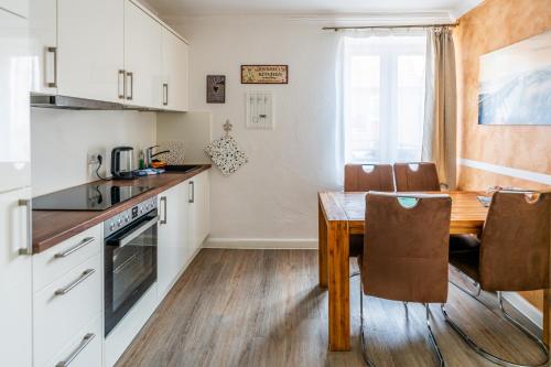 a kitchen and dining room with a table and chairs at Villa Backstein OBO19 in Schwerin