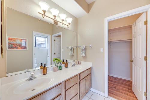 a bathroom with a sink and a large mirror at 2 Mi to Dtwn Condo with Patio in Mesa! in Mesa