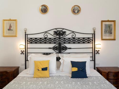 a bedroom with a black and white bed with pillows at Borgia di Firenze in Florence