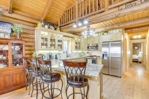 a kitchen with wooden ceilings and bar stools at Provo River Cabin with Private Bridge and Trail Access in Provo