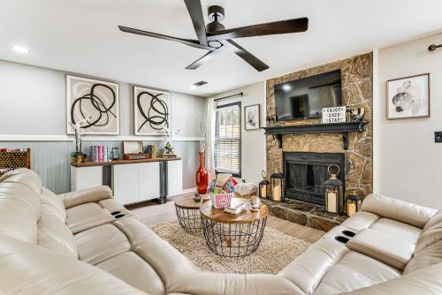 a living room with a couch and a fireplace at 4 Mi to Airport Atlanta Home with Deck and Hot Tub in Forest Park