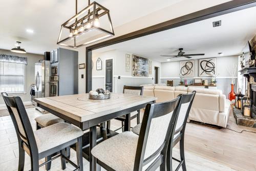 a dining room and living room with a table and chairs at 4 Mi to Airport Atlanta Home with Deck and Hot Tub in Forest Park