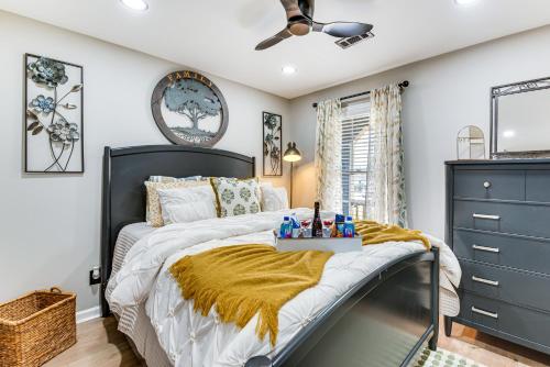 a bedroom with a bed and a ceiling fan at 4 Mi to Airport Atlanta Home with Deck and Hot Tub in Forest Park
