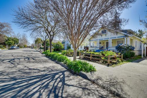 a house with a tree on the side of a street at 6 Blocks to SJSU Cozy Bungalow with Deck and Koi Pond in San Jose
