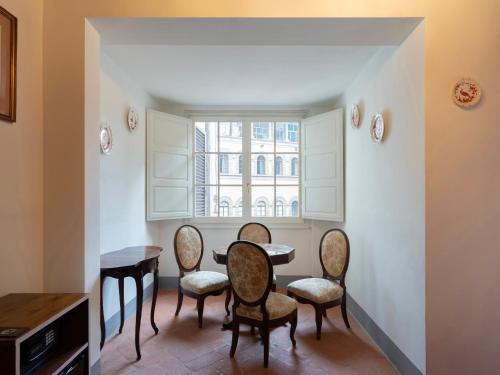 a dining room with a table and chairs and a window at Borgia di Firenze in Florence