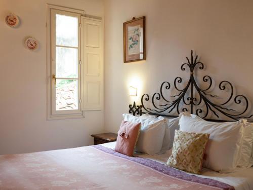 a bedroom with a large white bed with white pillows at Borgia di Firenze in Florence