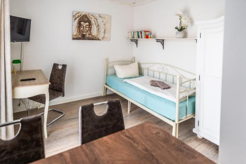 a small room with a bed and a table at Villa Backstein OBO19 in Schwerin