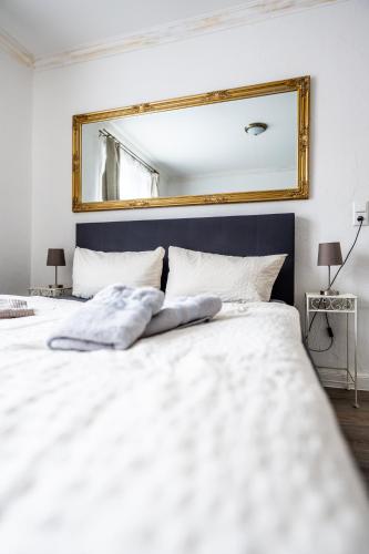 a bedroom with two beds with a mirror on the wall at Villa Backstein OBO19 in Schwerin