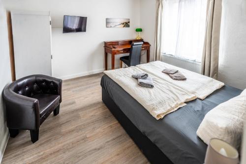 a bedroom with a bed and a desk and a chair at Villa Backstein OBO19 in Schwerin