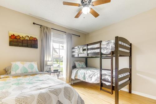 a bedroom with two bunk beds and a ceiling fan at 9 Mi to Clover Park Poolside Paradise! in Port Saint Lucie