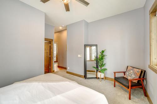 a bedroom with a bed and a chair at Chelan Mountain Retreat Chalet with Fire Pit! in Chelan