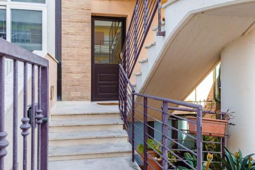 a house with a purple door and stairs at Italian Experience - Sea Suite in Porto Recanati