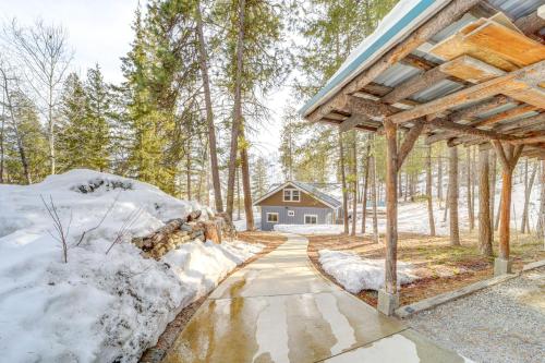 a house in the woods with snow on the ground at Chelan Mountain Retreat Chalet with Fire Pit! in Chelan